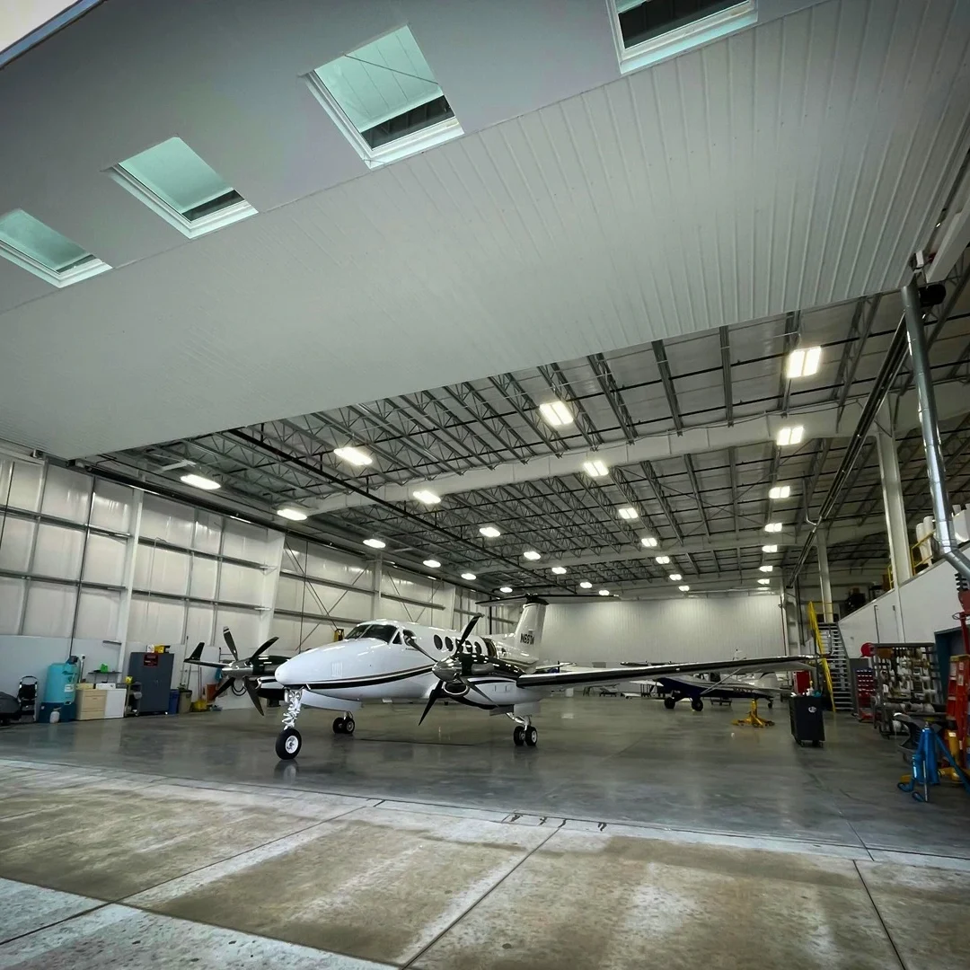 airplane in a steel aircraft hangar