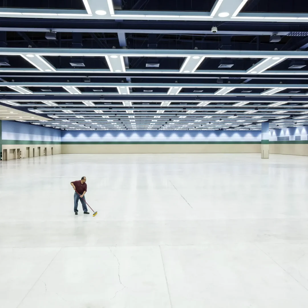 man mopping in a ice arena
